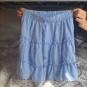 Light blue skirt, with floral print.